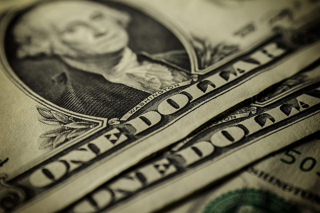 <p>Stack of dollar bills / Tom Bullock / Flickr</p>
